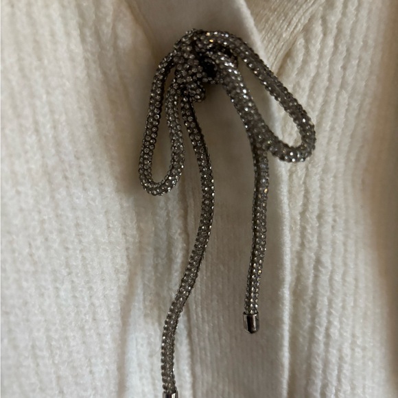 H&M cream sweater w two metal buttons and the top button has a jeweled bow. - Picture 2 of 3